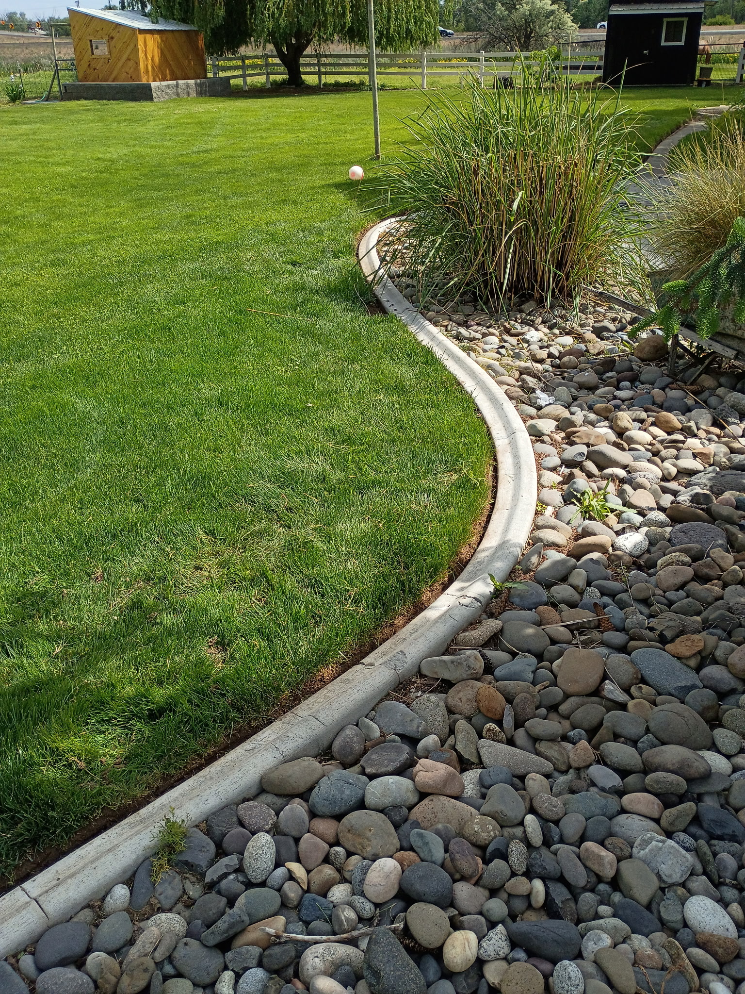 River rock bed with ornamental grasses